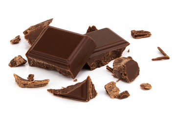 Milk chocolate pieces isolated on white background from top view