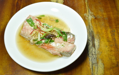 steamed salmon with soy sauce topping slice ginger on plate