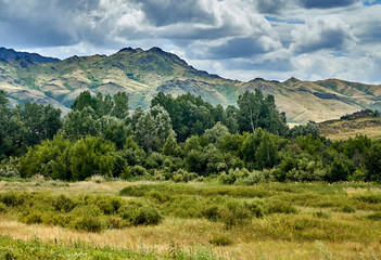 Beautiful landscape of steppe and stone mountains along the road from the city of Ust-Kamenogorsk to the Sibiny lakes (RU: Sibinskiye Ozora: Sadyrkol, Tortkara, Shalkar, Korzhynkol), East Kazakhstan