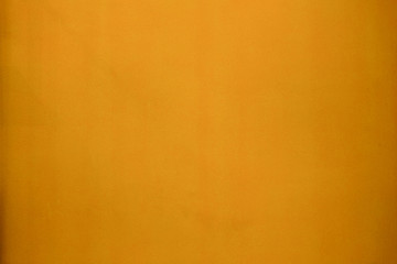 Bright yellow painted rough textured wall background