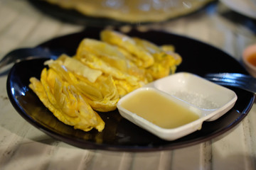 Crispy egg roti pancake served with condensed.