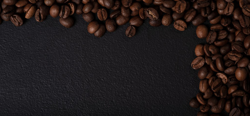 Coffee beans on black metal texture. Empty with copy space for ad text
