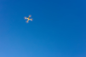 White drone flying over a blue sky
