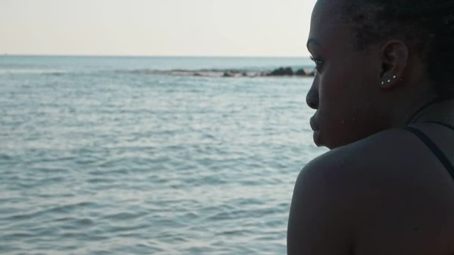 sad lonely black african migrant looking at the sea. Missing home-slow motion