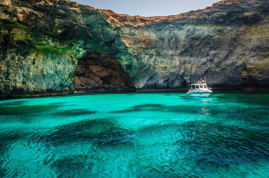 Blue Lagoon, Malta - the caves of the Blue Lagoon on the island of Comino on a bright sunny summer day with blue sky