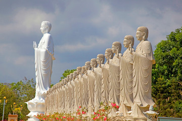 Large standing Buddha with 48 smaller standing buddhas, as part of Golden Buddhist temple complex,...