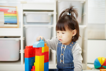toddler baby girl play toy blocks at home
