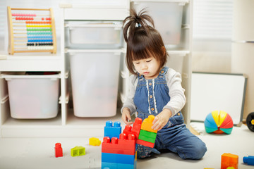 toddler baby girl play toy blocks at home