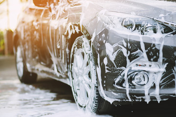 Outdoor car wash with foam soap.	