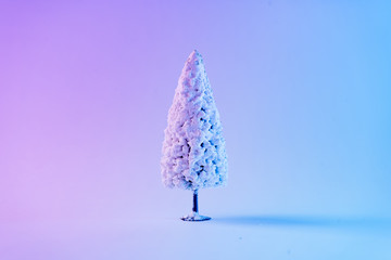 Snowy Christmas tree in vibrant bold gradient holographic colors. Concept art. Minimal New Year surrealism.