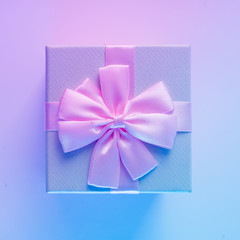 Gift box in vibrant bold gradient holographic colors. Christmas concept art. Minimal New Year surrealism.