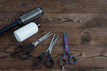 Professional hair dresser tools on wooden background  with copy space. Hair stylist equipment set....