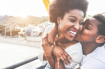 Happy young mother having fun with her child in sunny day