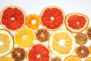 Dried slices of various citrus fruits on white background