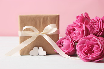 gift, flowers and hearts on a colored background. Background to Valentine's Day or Mother's Day. Holiday, give. International Women's Day.