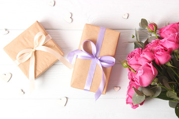 gift, flowers and hearts on a colored background. Background to Valentine's Day or Mother's Day. Holiday, give. International Women's Day.