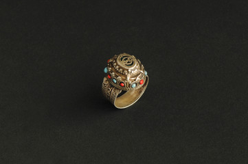 ancient antique ring with stones on black background. Middle-Asian vintage jewelry
