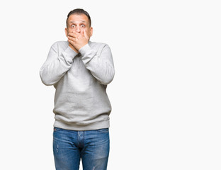 Fototapeta premium Middle age arab man wearing sport sweatshirt over isolated background shocked covering mouth with hands for mistake. Secret concept.