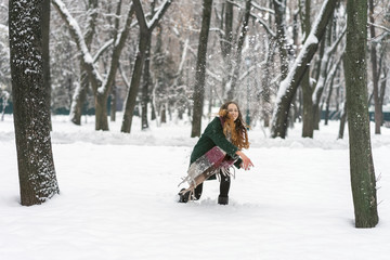 woman in the park throwing snowballs