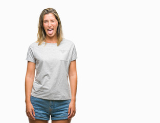 Obraz premium Young beautiful woman over isolated background sticking tongue out happy with funny expression. Emotion concept.
