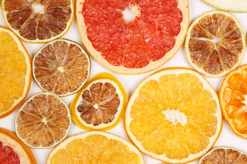 Dried slices of various citrus fruits on white background
