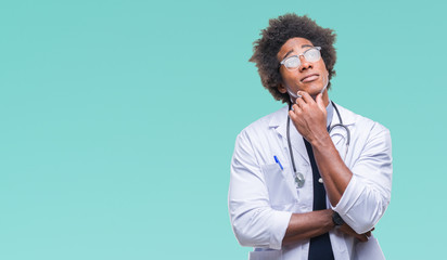 Fototapeta na wymiar Afro american doctor man over isolated background with hand on chin thinking about question, pensive expression. Smiling with thoughtful face. Doubt concept.