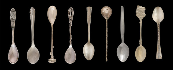 9 Vintage Tea Spoons isolated on a black background. Rustic style. Silverware.