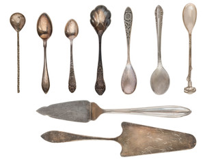 Vintage Silverware, antique spoons, knives, cake shovels isolated on isolated white background. Antique silverware. Retro.