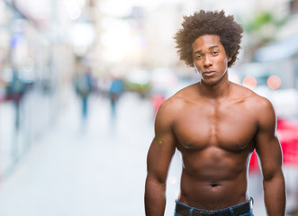 Fototapeta na wymiar Afro american shirtless man showing nude body over isolated background skeptic and nervous, frowning upset because of problem. Negative person.