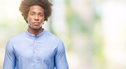 Afro american man over isolated background with serious expression on face. Simple and natural looking at the camera.