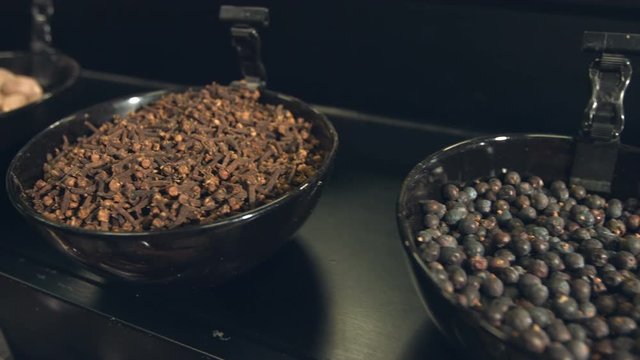 Spices in bowls.
Department with spices in the store. Whole carnation, juniper dried berries, whole nutmeg, ground cardamom, ground ginger, spice pepper.