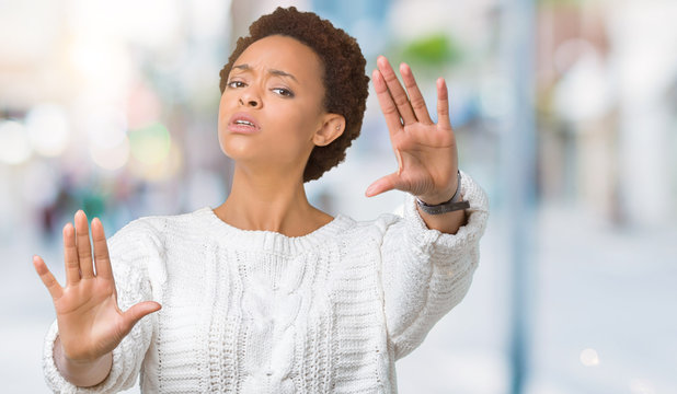 Beautiful young african american woman wearing sweater over isolated background Smiling doing frame using hands palms and fingers, camera perspective
