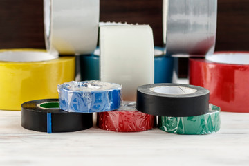 A few rolls of duct tape stack of electrical tape stand nearby. have toning. shallow depth of cut