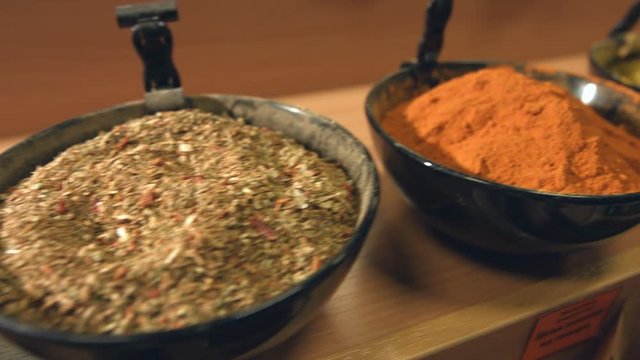 Spices in bowls.
Department with spices in the store. Red paprika, spice pepper, ground cardamom, ground ginger, cumin zira, cayenne pepper, hops-suneli.