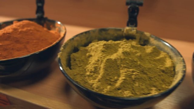Spices in bowls.
Department with spices in the store. Red paprika, spice pepper, ground cardamom, ground ginger, cumin zira, cayenne pepper, hops-suneli.