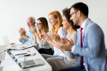 Multiracial young business people .clapping hands in office