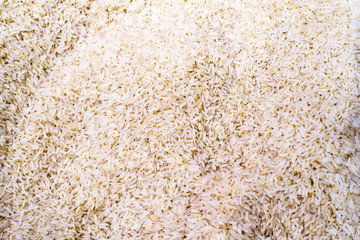 Dry uncooked rice, texture background, top view. 