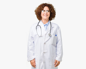 Middle ager senior doctor woman over isolated background with a happy and cool smile on face. Lucky...