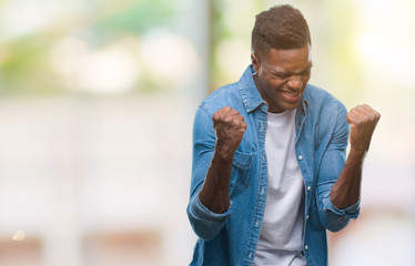 Young african american man over isolated background very happy and excited doing winner gesture with arms raised, smiling and screaming for success. Celebration concept.