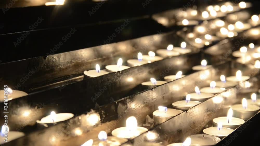 Wall mural burning candles on the church altar. christmas midnight mass. prayer candles in a catholic church. c