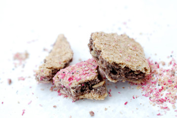 peices of a chopped cereal bar with tasty berry crumbles