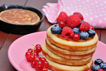 Pancakes with fresh berries and orange juice