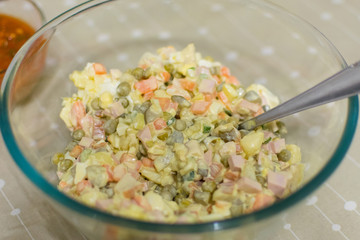 Russian traditional salad Olivier with vegetables and meat. Winter salad