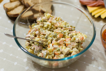Russian traditional salad Olivier with vegetables and meat. Winter salad
