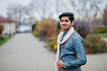 Indian man wear on traditional clothes with white scarf posed outdoor.
