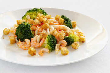 steamed broccoli and fried calamari and shrimps salad with spicy croutons