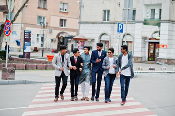 Obraz premium Group of six south asian indian mans in traditional, casual and business wear walking at crosswalk together.