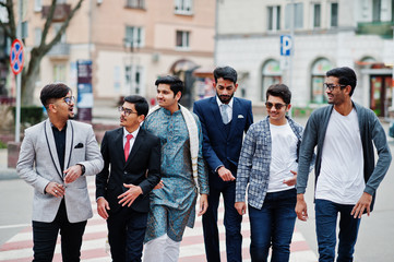 Group of six south asian indian mans in traditional, casual and business wear walking at crosswalk...