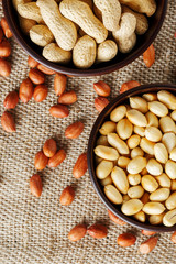 Peanuts in the shell and peeled closeup in a cup