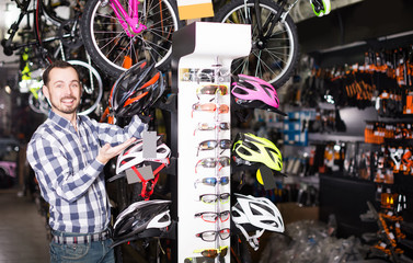 Man demonstrates  helmets for cycling